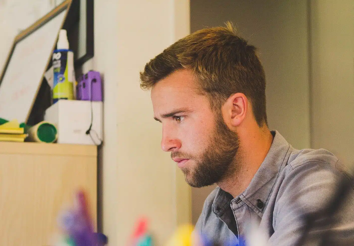 Junger Mann im Büro am Schreibtisch